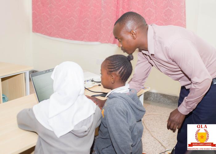 Pupils working at the Golden Learners computer lab with a teacher